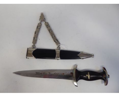 A German Nazi Stormtroopers dagger, the handle and the RZM blade with emblems&nbsp; 8.75"L in a black steel sheath, on a chai