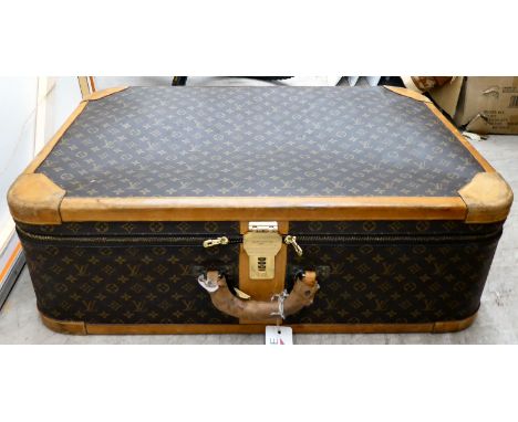 A Louis Vuitton suitcase with a double zipped opening and a combination lock&nbsp; 11" x 31"