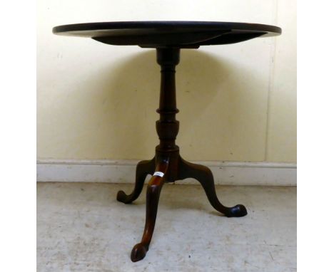 An early 19thC mahogany tip-top pedestal table, over a ring turned column, raised on a cabriole tripod base and pointed toes&