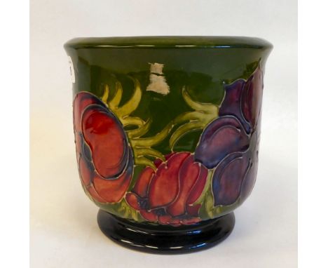 A Moorcroft pottery planter with straight sides and an inverted rim, raised on splayed footrim, decorated in a version of the