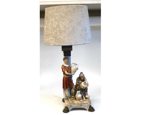 A 20thC Royal Dux ceramic table lamp, fashioned as a Biblical group, depicting a young man and woman, producing water vessels