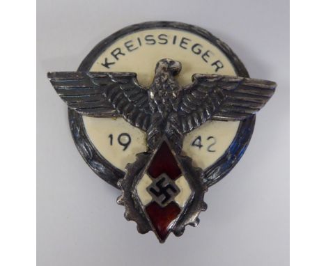 A German enamelled Gau badge, inscribed 'Kreissieger 1942' (Please Note: this lot is subject to the statement made in the Auc