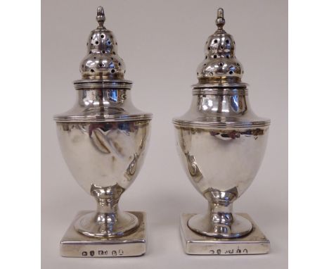 A pair of Georgian silver, loaded pedestal, vase design pepper pots with detachable lids and finials&nbsp; TD&nbsp; London 18