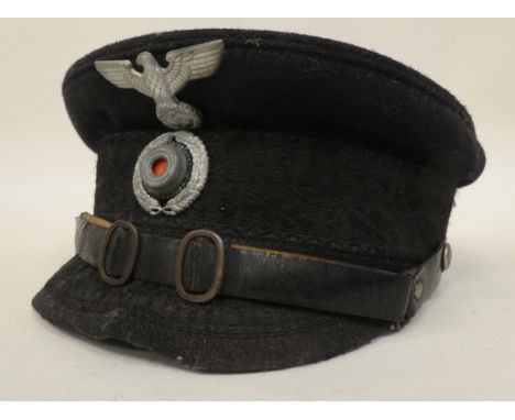 A German Nazi black peaked cap with emblems (Please Note: this lot is subject to the statement made in the Auctioneers Glossa