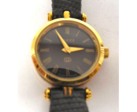 A lady's Gucci gilded and black cased wristwatch, faced by a black Roman dial, on a dedicated black hide strap