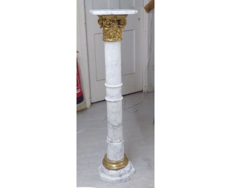 A white and grey mottled marble column with a gilt composition Corinthian capital