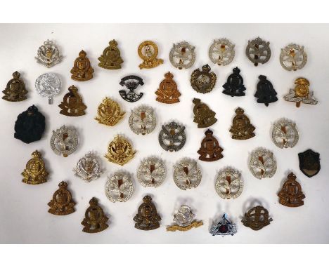 Approximately thirty-five British military cap badges: to include Royal Army Ordnance Corps; Glider Pilot Regiment; and Recon