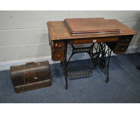 A VINTAGE SINGER TREADLE SEWING MACHINE, along with an oak cased singer sewing machine (condition report: -aged wear and tear