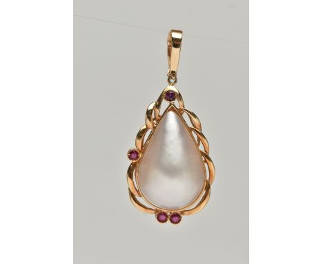 A MABE PEARL AND RUBY PENDANT, a pear Mabe pearl collet set in yellow metal accented with four circular cut rubies, open work