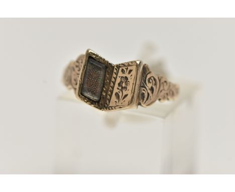A VICTORIAN MOURNING RING, yellow metal ring in the form of an open book, one side with a vacant glass panel, floral detail a