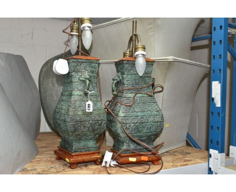 A PAIR OF TABLE LAMPS, bronzed style lamp bases with pale green shades, height 65cm to top of finial, two bulbs per lamp, tog