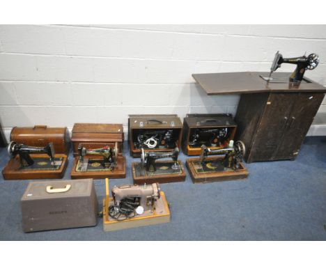 A SELECTION OF VINTAGE SINGER SEWING MACHINES, to include a four wooden cased, three others, and a treadle sewing machine (co