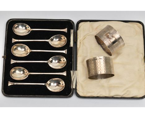 A CASED SET OF SILVER TEASPOONS AND TWO NAPKIN RINGS, teaspoons hallmarked 'Josiah Williams &amp; Co' London 1930, together w