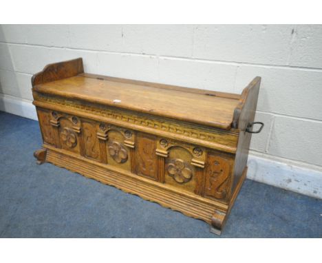 AN EARLY 20TH CENTURY OAK HALL BENCH, with quatrefoil and seahorse panels, and twin handles, width 115cm x depth 47cm x heigh