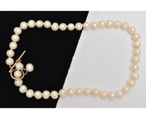 A CULTURED PEARL NECKLACE, a string of baroque cultured pearls, fitted with a yellow gold toggle clasp, approximate length 44