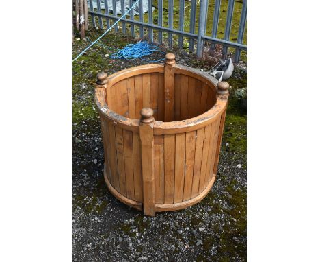 A WOODEN CYLINDRICAL GARDEN PLANTER, diameter 76cm x height 74cm (condition - ideal for restoration due to one finial broken,