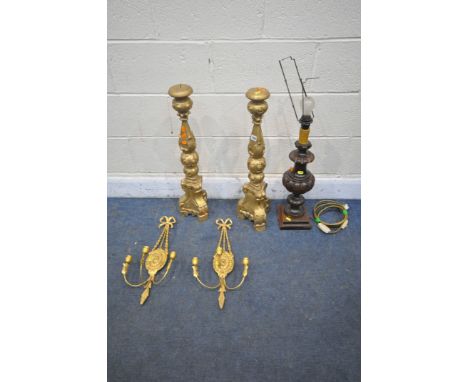 A PAIR OF GILTWOOD ALTER CANDLE STICKS, a pair of wall sconces with triple holders, and a wooden table lamp (condition report