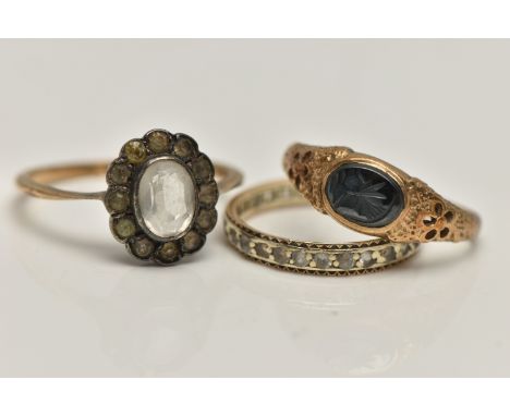 THREE GEM SET RINGS, to include an AF 9ct gold hematite intaglio signet ring, open work detailed shoulders leading onto a pol
