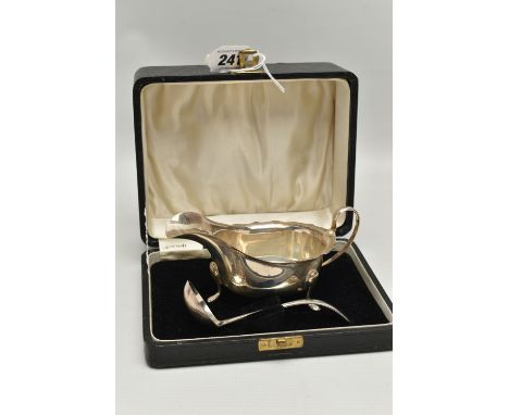 A CASED GEORGE V SILVER SAUCE BOAT AND LADLE, the sauceboat with wavy rim and on three cabriole legs with pad feet, makers Vi