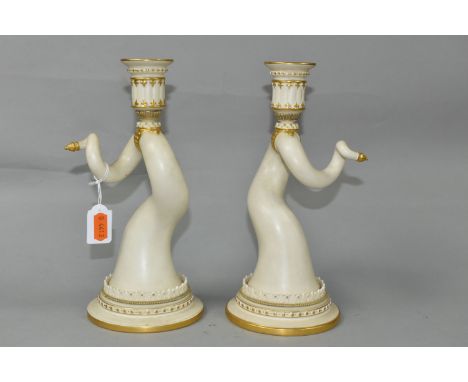 A PAIR OF ROYAL WORCESTER PORCELAIN CANDLESTICKS, in the form of twisted animal horns, each mirroring the other, with gilt an