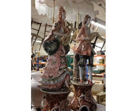 A pair of Italian pottery standard lamps by Danese modelled as a male and female musician in 18th century dress, brass fittin