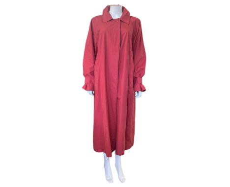 A Burberrys' brick red Camden trench coat with nova check lining, order number in pocket lining, L (1)

Good condition commen
