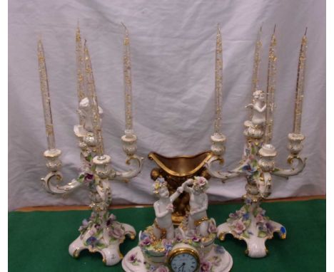 &nbsp;2x Capodimonte candelabras with cherubs, glass candles. Also a Capodimonte quartz mantel clock. A gold effect vase also