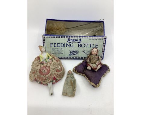 Antique baby miniature dolls and a boxed feeding bottle; to include a small 3 ins articulated all bisque baby doll on origina
