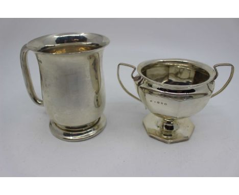 A plain silver christening mug with stepped foot and loop handle, Birmingham 1919, 10cm high, 164g and a Victorian octagonal 