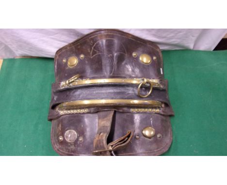 A heavy horse leather saddle/harness with brass buckle and hoops.