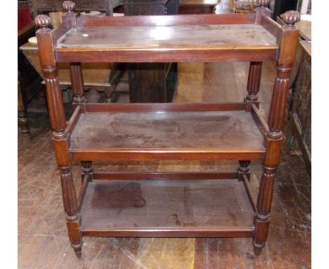 A Victorian three tiered mahogany hostess trolley. With ceramic casters. Height 122cm, width 89cm, depth 43.5cm.
