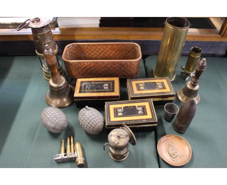 A miner's lamp, a trench art lighter in the form of a bullet, three metal cash boxes, blank hand grenade housings, two brass 