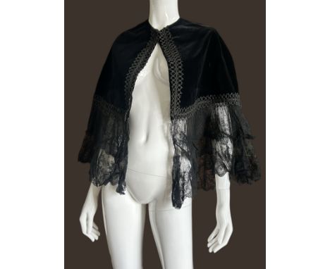 Two late 19th century black capes, an early 20th century white cotton with Ayrshire embroidery (probably for a child) and a B