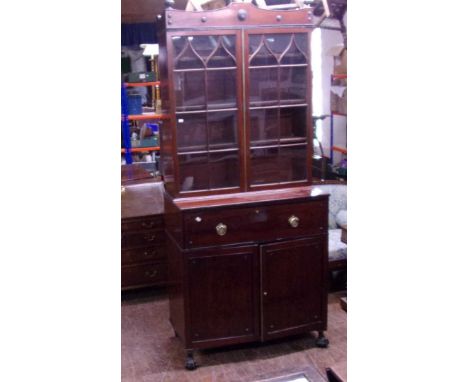 A large secretaire/bureau, with glazed bookcase above.Hooped brass handles, Ball and claw feet. Missing glass pane in bookcas