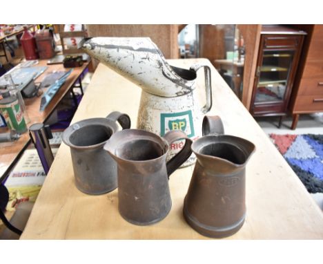 A collection of vintage oil jugs including BP.