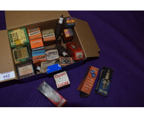 A collection of vintage spark plug and light bulb display boxes.