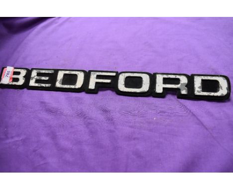 A vintage Bedford truck engine badge