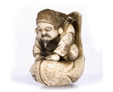 Ivory netsuke of Ebisu Japanese, late Meiji the patron of Fishermen seated upon and calming a large Tai fish from the legend 