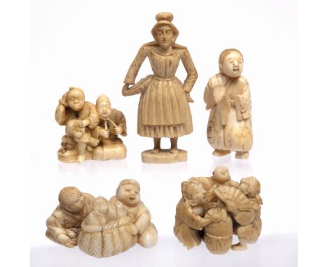 Ivory netsuke of two men and a child Japanese, 19th Century seated and standing around a basket and rice bale, signed Masamit