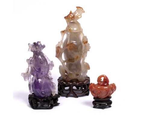Agate vase and cover Chinese 19th Century carved with trailing foliage and with bird finial,25 cm, a small Chinese cornelian 
