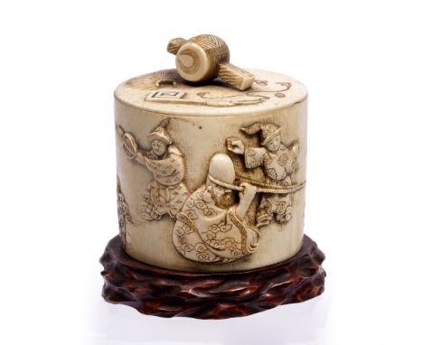 Ivory tusk box and cover Japanese, late Meiji carved in relief with Hotei and Fukurokoja kubihiki wrestling watched by youths