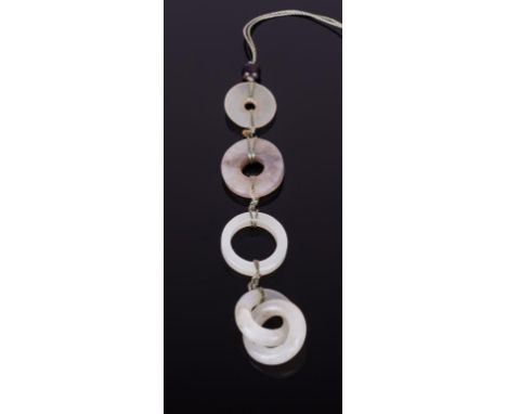 Qing dynasty, four jade disk ring tied up on  a string as an ornament; 5/8 in. w