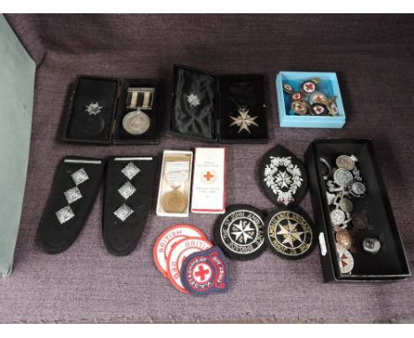 A collection of St John's Ambulance and Red Cross Medals, Badges and Epaulettes including Order of St John's with ribbon in c