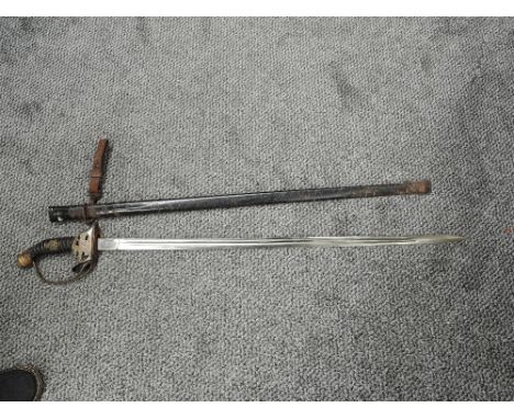 A German Infantry Officers Sword pattern 1911 similar to 1889 pattern but with hinged guard, includes badge on grip, no maker