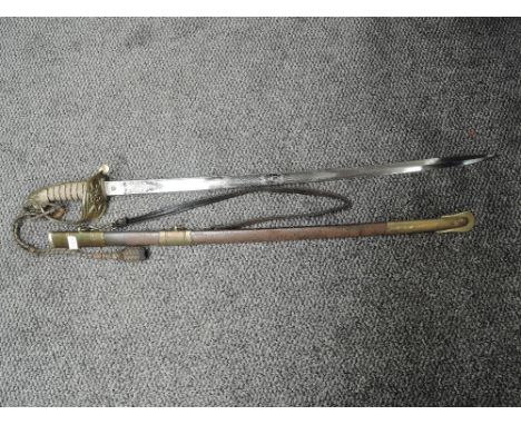 A British Naval Officers Sword with metal scabbard, sword has lion's head pommel and enclosed hilt with Royal Cypher, engrave