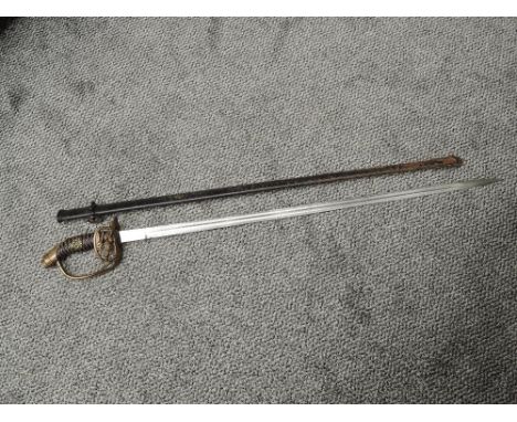 A German Infantry Officers Sword pattern 1911 similar to 1889 pattern but with hinged guard, includes badge on grip, no maker