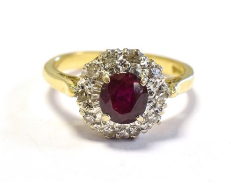 18CT GOLD RUBY &amp; DIAMOND CLUSTER RING 10.6mm diameter, halo style cluster, set with an oval ruby, of very good quality (i