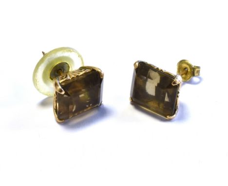 9CT GOLD SMOKY QUARTZ STUD EARRINGS claw set with octagonal step cut smoky quartz stones, with pierced scroll galleries, on w