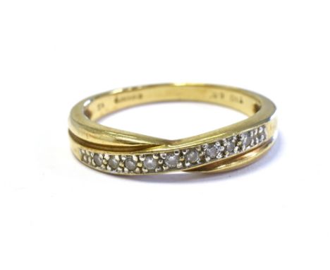 9CT GOLD &amp; DIAMOND SET ETERNITY RING a cross over band style head, grain set with round brilliant cut diamonds, reported 