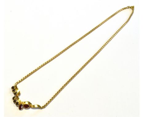 18CT GOLD GARNET SET LAVALIER 43cm long, with a claw set garnet and red paste stone centre piece, secured with a bolt ring cl